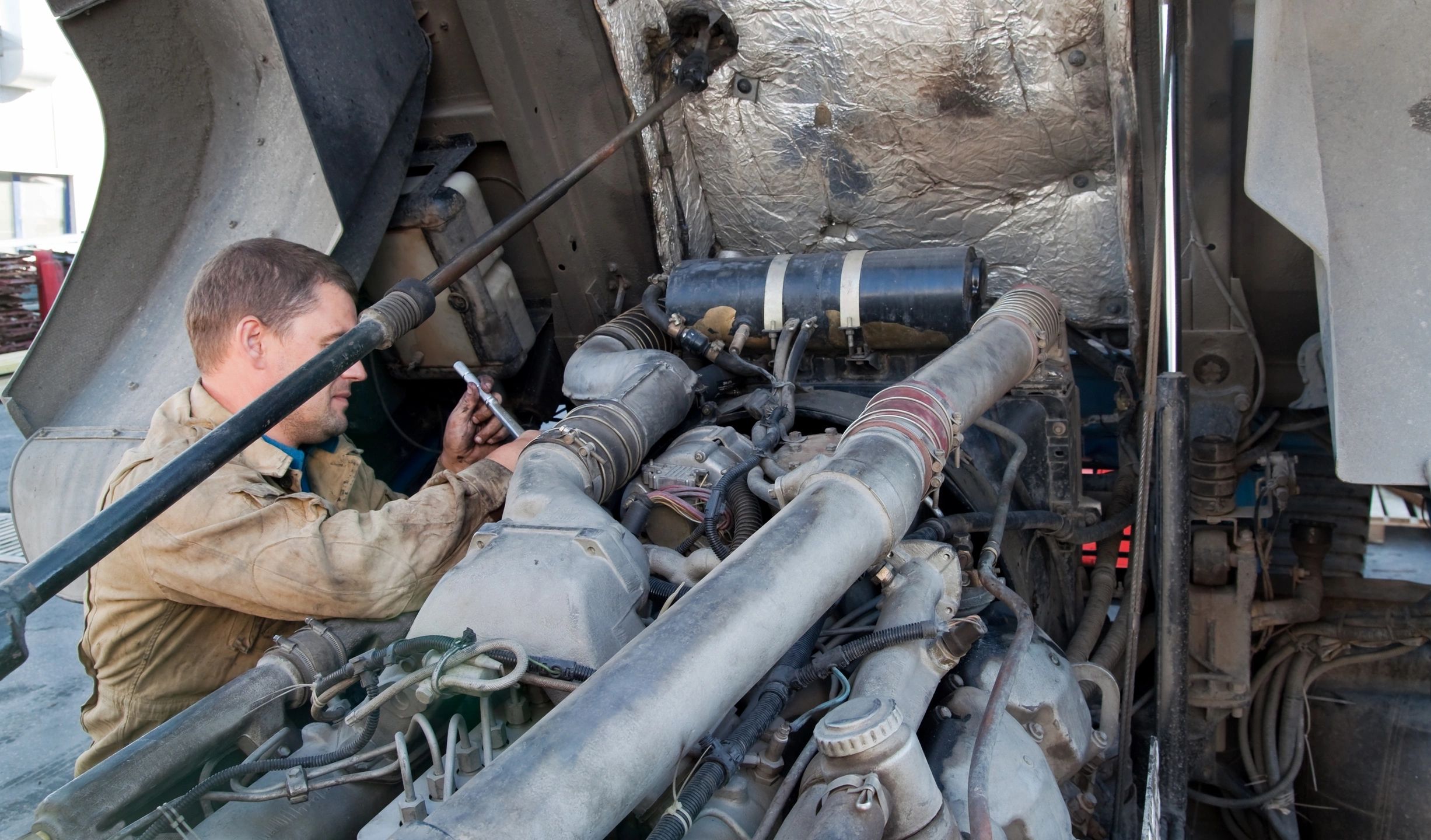 Mechanic performing truck engine maintenance